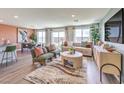 Open-concept living room featuring modern furniture and sliding glass doors to the backyard at 3402 La Cura Ave # Lot 69, Las Vegas, NV 89141