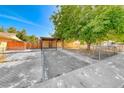 Charming single-story home featuring a spacious front yard with mature trees and covered parking at 4100 Montebello Ave, Las Vegas, NV 89110
