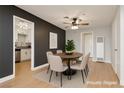 Dining area featuring a round table with chairs, contrasting walls, and modern lighting at 419 National St, Henderson, NV 89015
