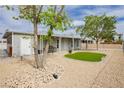 This home boasts a well-kept gravel yard, bench, and a quaint entranceway at 419 National St, Henderson, NV 89015