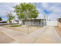 Attractive home with a long driveway, chain link fence, and well-kept lawn area at 419 National St, Henderson, NV 89015