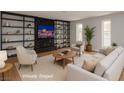 Bright living room with a cozy fireplace, built-in shelving, neutral paint, and ample natural light at 419 National St, Henderson, NV 89015
