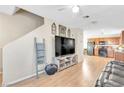 Inviting living room with laminate flooring and staircase with an open concept layout at 4195 Story Rock St, Las Vegas, NV 89115