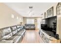 Spacious living room with laminate flooring, a ceiling fan and a flat-screen television at 4195 Story Rock St, Las Vegas, NV 89115