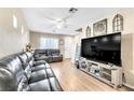 Comfortable living area features wood-look laminate flooring and a neutral color palette at 4195 Story Rock St, Las Vegas, NV 89115