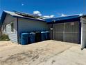 Exterior view of the home with a gated carport and solar panels on the roof at 4682 Tamalpias Ave, Las Vegas, NV 89120
