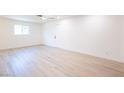 Bright bedroom featuring wood-look flooring, a ceiling fan and white walls at 508 S Jones Blvd, Las Vegas, NV 89107