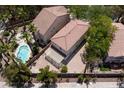 Aerial view of a home with a tile roof, a backyard pool, and a brick patio at 5516 Ness Ave, Las Vegas, NV 89118