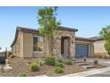 Single-story home featuring stone accents, a two-car garage, and low-maintenance landscaping at 58 Sun Lily Ln, Henderson, NV 89011