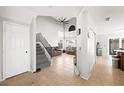 Bright, open living room with tile floors, high ceilings, staircase, and comfortable seating at 5950 Pacific Shores Dr, Las Vegas, NV 89142