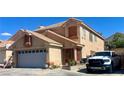 Two-story tan home with a tile roof, attached two-car garage, and a white RAM truck in the driveway at 6429 Rosemount Ave, Las Vegas, NV 89156