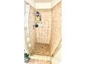 Tiled shower featuring glass door and tiled floor at 6429 Rosemount Ave, Las Vegas, NV 89156