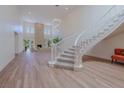 Open-concept foyer with a staircase leading to the upper level and a view of the living room at 7625 Spanish Bay Dr, Las Vegas, NV 89113