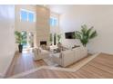 Bright living room boasts high ceilings, modern fireplace, and seamless indoor-outdoor flow to the pool area at 7625 Spanish Bay Dr, Las Vegas, NV 89113