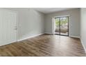 Open living room featuring wood floors, a balcony, and lots of natural light at 8250 N Grand Canyon Dr # 1123, Las Vegas, NV 89166