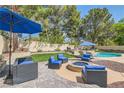 Well-maintained backyard with a cozy fire pit area and comfortable seating for outdoor entertaining at 8320 Opal Cove Dr, Las Vegas, NV 89128