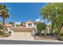 Charming two-story home with a well-manicured lawn, mature trees, and a three-car garage at 8320 Opal Cove Dr, Las Vegas, NV 89128