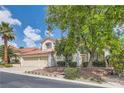 Inviting two-story home with a well-manicured front yard, mature trees, and a three-car garage at 8320 Opal Cove Dr, Las Vegas, NV 89128