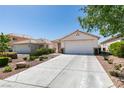 Single story home with a two car garage and a long driveway at 8877 Perfect Diamond Ct, Las Vegas, NV 89129
