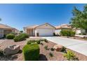 Single story home with a two car garage and desert landscaping at 8877 Perfect Diamond Ct, Las Vegas, NV 89129