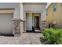 Inviting entryway with stone pillars, brick pathway, and a modern front door at 8898 Sasquatch Run Ave, Las Vegas, NV 89166