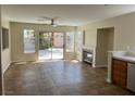Open-concept living area with tile flooring, fireplace, and sliding door access to patio at 9004 Dulcimer Ln, Las Vegas, NV 89123