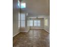 Bright living room features tile floors, tall windows, and lots of natural light at 9004 Dulcimer Ln, Las Vegas, NV 89123