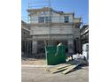 New two story house construction site with scaffolding, a dumpster, and building materials at 9094 Rivington Ave, Las Vegas, NV 89148