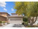 A charming two-story home with a well-maintained front yard, and a two-car garage showcasing suburban charm at 9218 Grassy Weep Ct, Las Vegas, NV 89178