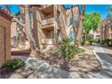 Picturesque view of a multi-story condo building with mature trees and well-maintained landscaping at 9325 W Desert Inn Rd # 120, Las Vegas, NV 89117