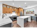 Modern kitchen with stainless steel appliances, custom cabinets, quartz countertop island, and subway tile backsplash at 10432 Britton Hill Ave, Las Vegas, NV 89129