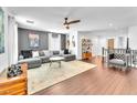 Spacious living area features modern ceiling fan, recessed lighting, and sleek hardwood flooring at 10432 Britton Hill Ave, Las Vegas, NV 89129