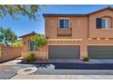 Charming two-story townhome featuring an attached garage and manicured landscaping at 1139 Via Partito, Henderson, NV 89052
