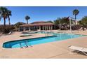 Community pool featuring ample seating, palm trees and a covered lounge area at 1139 Via Partito, Henderson, NV 89052