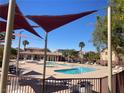 Community pool featuring lounge chairs, shade sails, and palm trees at 1139 Via Partito, Henderson, NV 89052