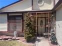 Protected front porch with security door, tasteful landscaping, and decor at 1281 Challenge Ln, Las Vegas, NV 89110