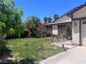 Well maintained front yard with a green lawn and an assortment of decorative lawn ornaments at 1281 Challenge Ln, Las Vegas, NV 89110