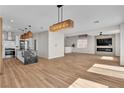 Open concept living space with kitchen, living room, hardwood floors and modern finishes at 1551 Boundary Peak Way, Las Vegas, NV 89135