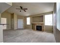 Cozy living room featuring a classic fireplace, neutral carpet, and bright natural light at 1608 Sussex St # 204, Las Vegas, NV 89144