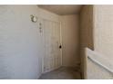 Close-up of unit 204 entryway featuring a sturdy security door and wall sconce at 2191 Bay Club Dr # 204, Laughlin, NV 89029