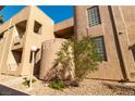 Tan stucco condo building featuring desert landscaping and walkways at 2191 Bay Club Dr # 204, Laughlin, NV 89029