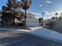 Inviting two-story home with a large driveway and a well-kept front yard with mature landscaping at 2821 Willow Wind Ct, Las Vegas, NV 89117