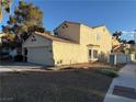 Side view of a two-story home with a tile roof and low maintenance landscaping at 2821 Willow Wind Ct, Las Vegas, NV 89117