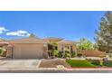 Daytime view of a single-story home with a two-car garage and well-maintained landscaping at 3 Chatmoss Rd, Henderson, NV 89052