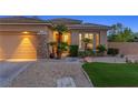 Close up of charming single-story home with stone accents and beautiful landscaping at 3 Chatmoss Rd, Henderson, NV 89052