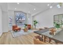 Bright living area showcasing a large window, modern seating, and dining space at 3109 Siena Cir, Las Vegas, NV 89128