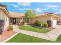 Attractive home featuring a well-kept lawn, mature landscaping, and a two-car garage at 3436 Camsore Point Ln, Las Vegas, NV 89129