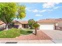 Charming single-story home with a manicured front lawn and a two car garage at 3436 Camsore Point Ln, Las Vegas, NV 89129
