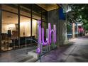 Contemporary building entrance with large windows showcasing the interior design and vibrant Juhl signage at 353 E Bonneville Ave # 1302, Las Vegas, NV 89101
