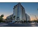 Modern high-rise condo building with balconies and palm trees at 353 E Bonneville Ave # 1302, Las Vegas, NV 89101